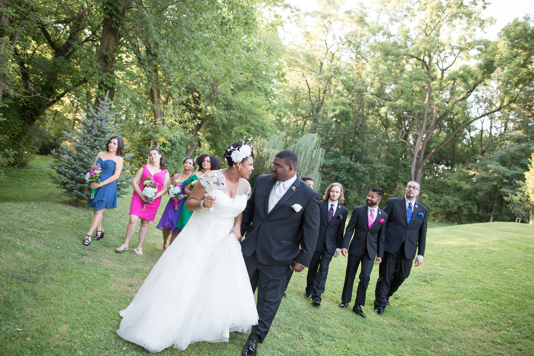 Bride and groom walking with bridal party at Riverdale Manor
