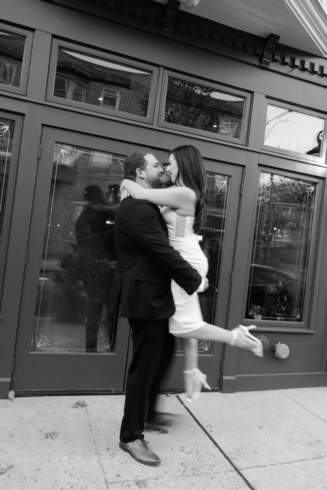 Motion blur black and white photo of a couple downtown outside Rubicon
