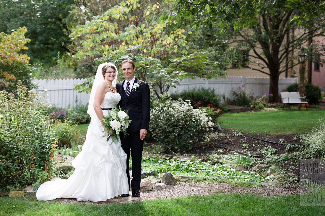 Bride and groom by fountain at the Lititz Museum Garden