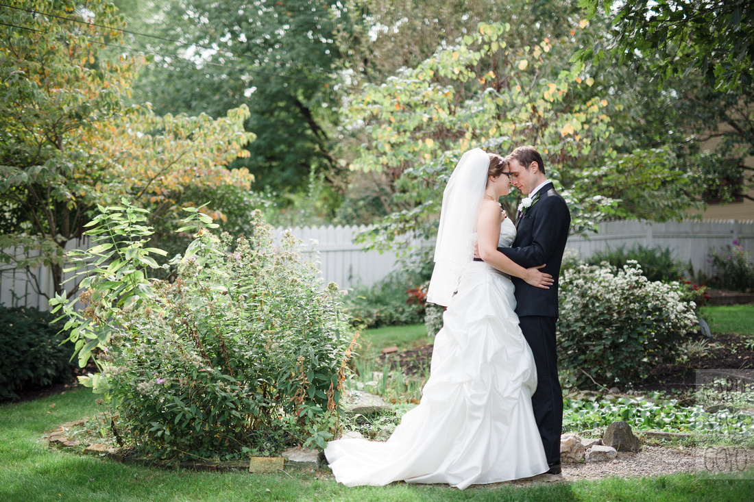Bride and groom by fountain at the Lititz Museum Garden