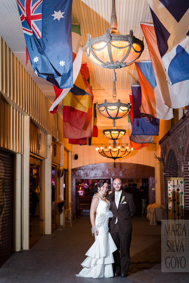Bride and groom by the flags at Stoudt's