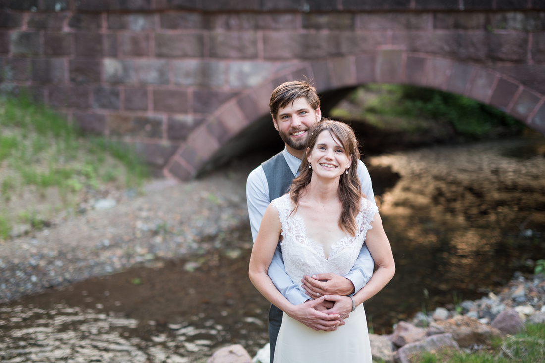 Bride and groom portrait by the creek.