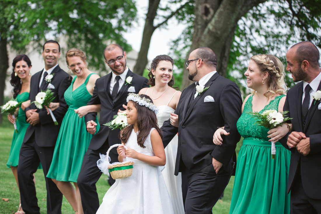Couple walking with Bridal Party at Stock's Manor