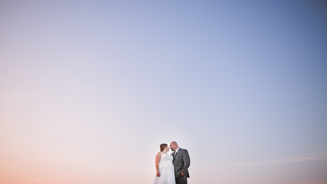Bride and groom with sunset sky