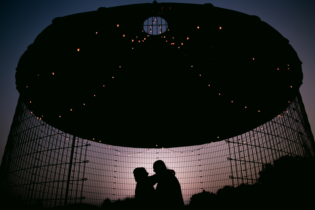 Bride and groom in the corn house at sunset