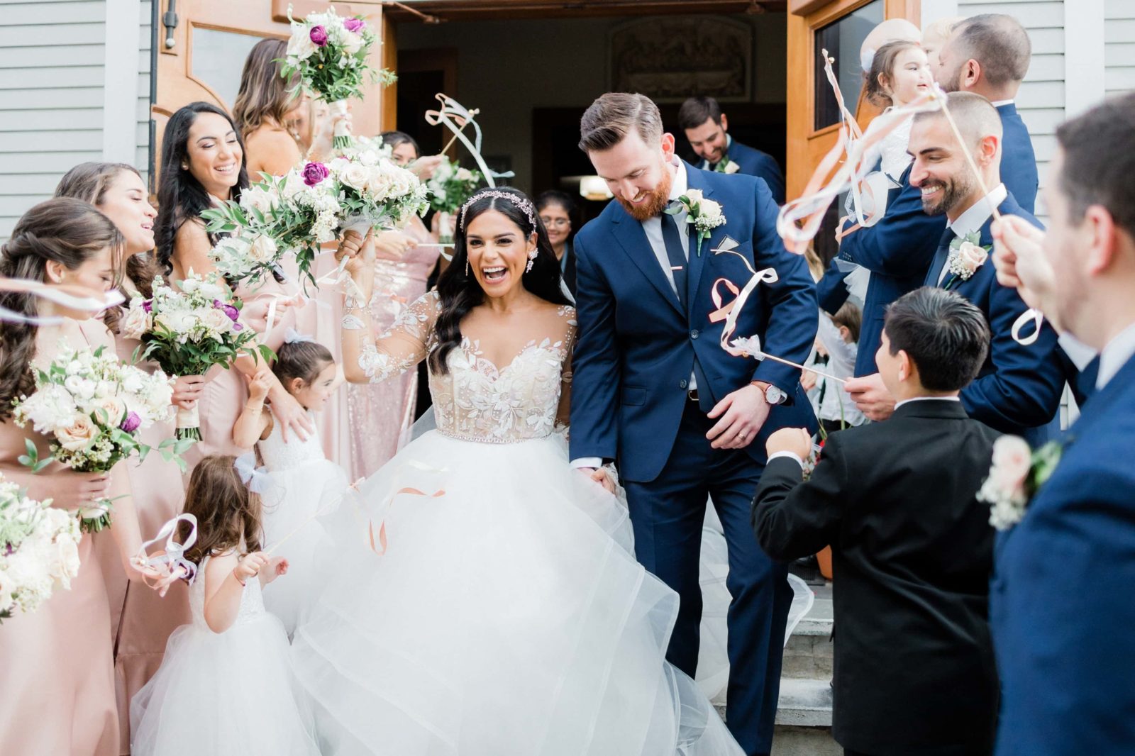 Bride and groom coming out of Saint Agnes church before heading to Brecknock Hall for reception