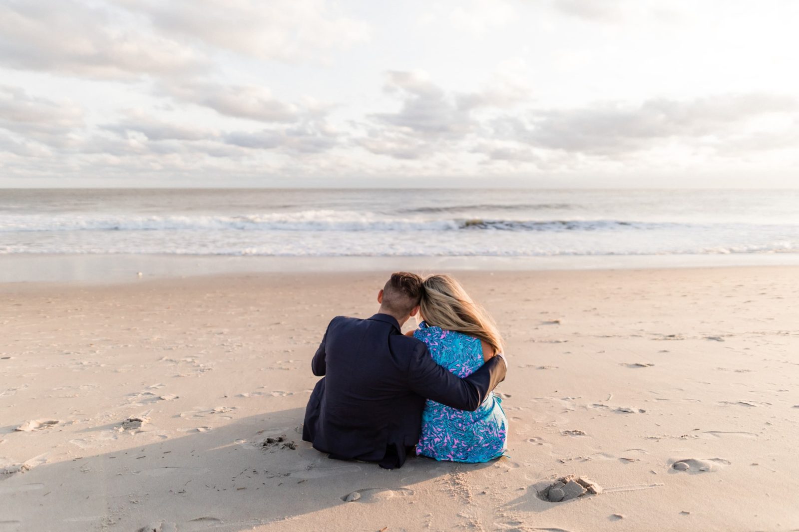 Cute photo of couple sitting together looking at the water in Cape May