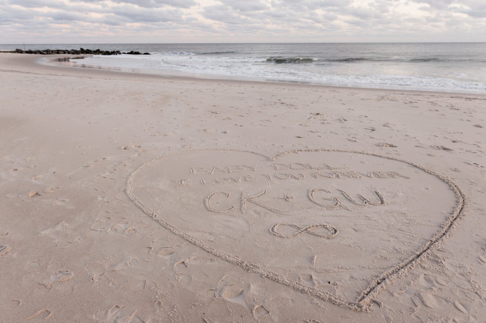 Heart writing on the sand for beach proposal