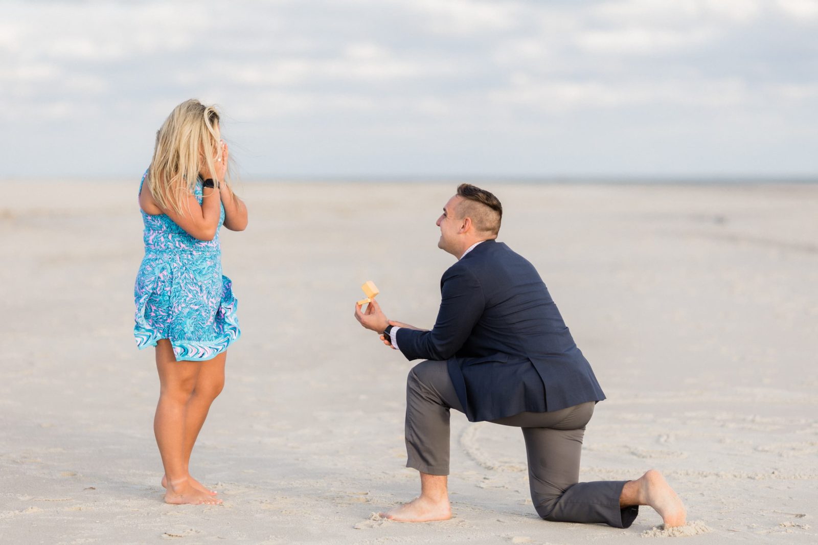 Guy on one knee at sunset in Cape May NJ beach proposal