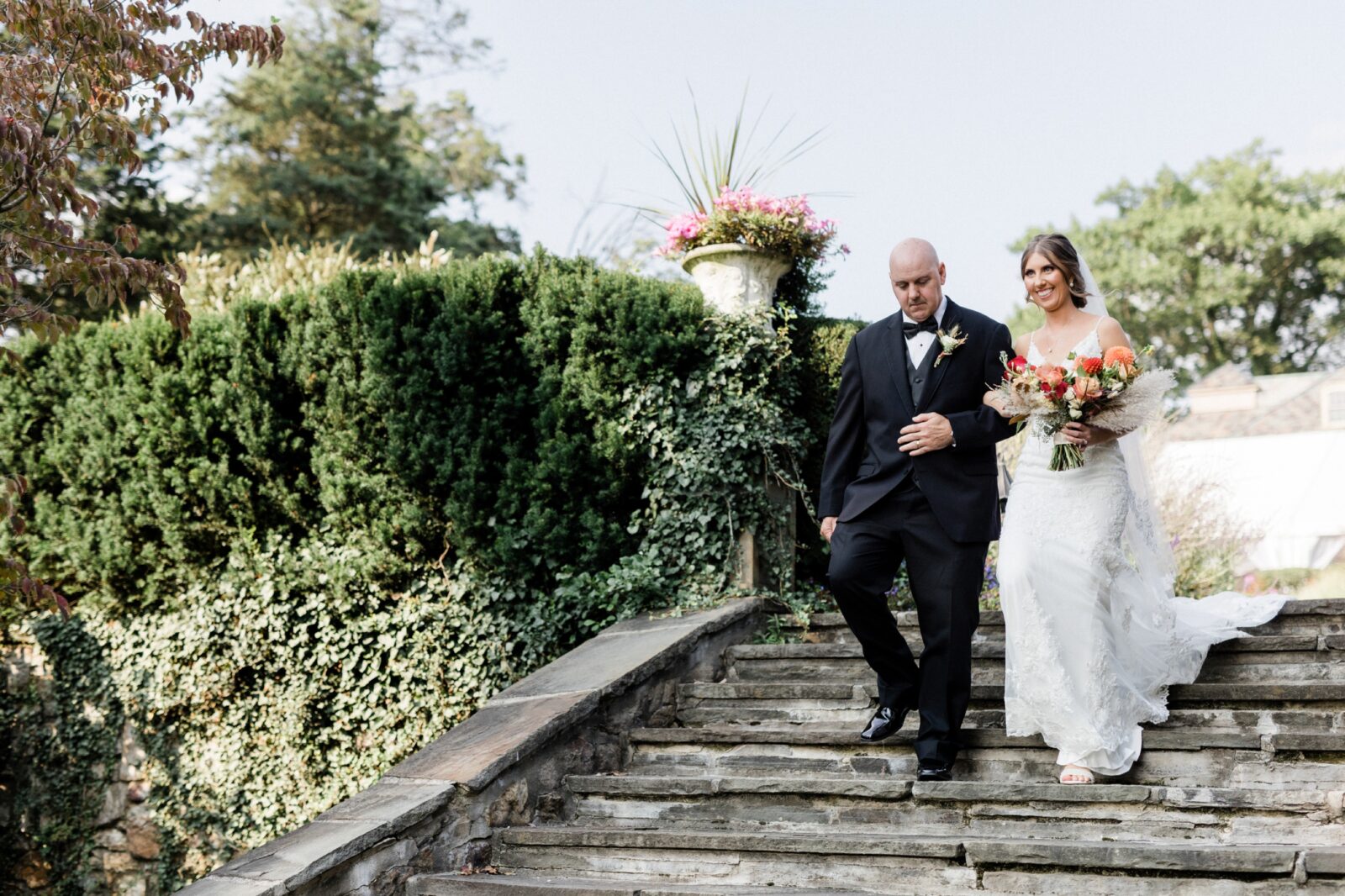 Bride walking down the stairs with her father to the garden ceremony at Box Hill Mansion, photographed by Maria Silva-Goyo Photography
