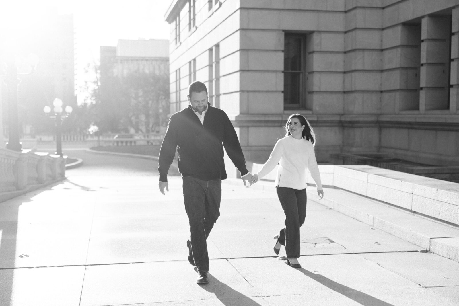 black and white photo of a couple walking at the capitol complex in downtown harrisburg