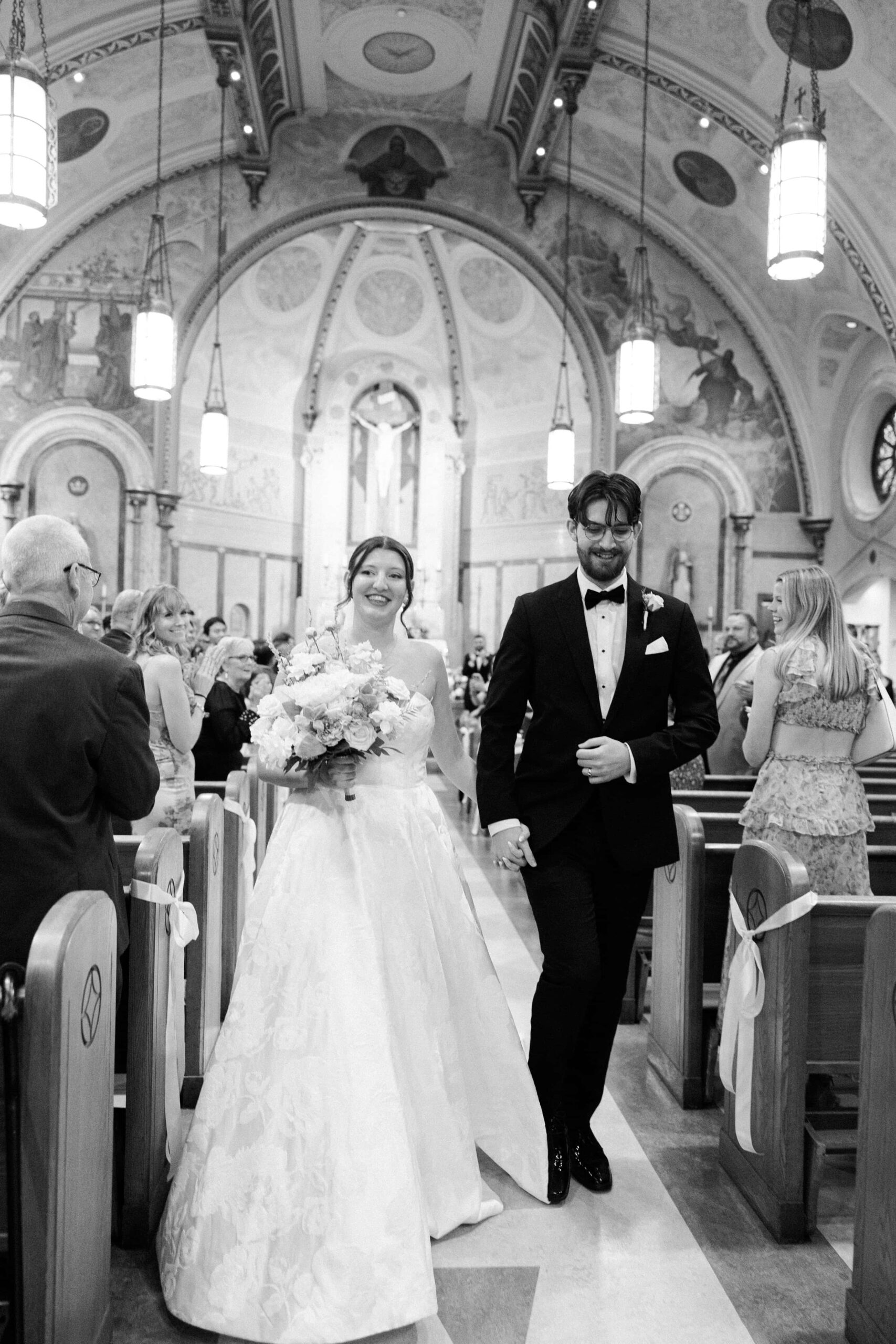 Bride and groom walking up the isle after the ceremony